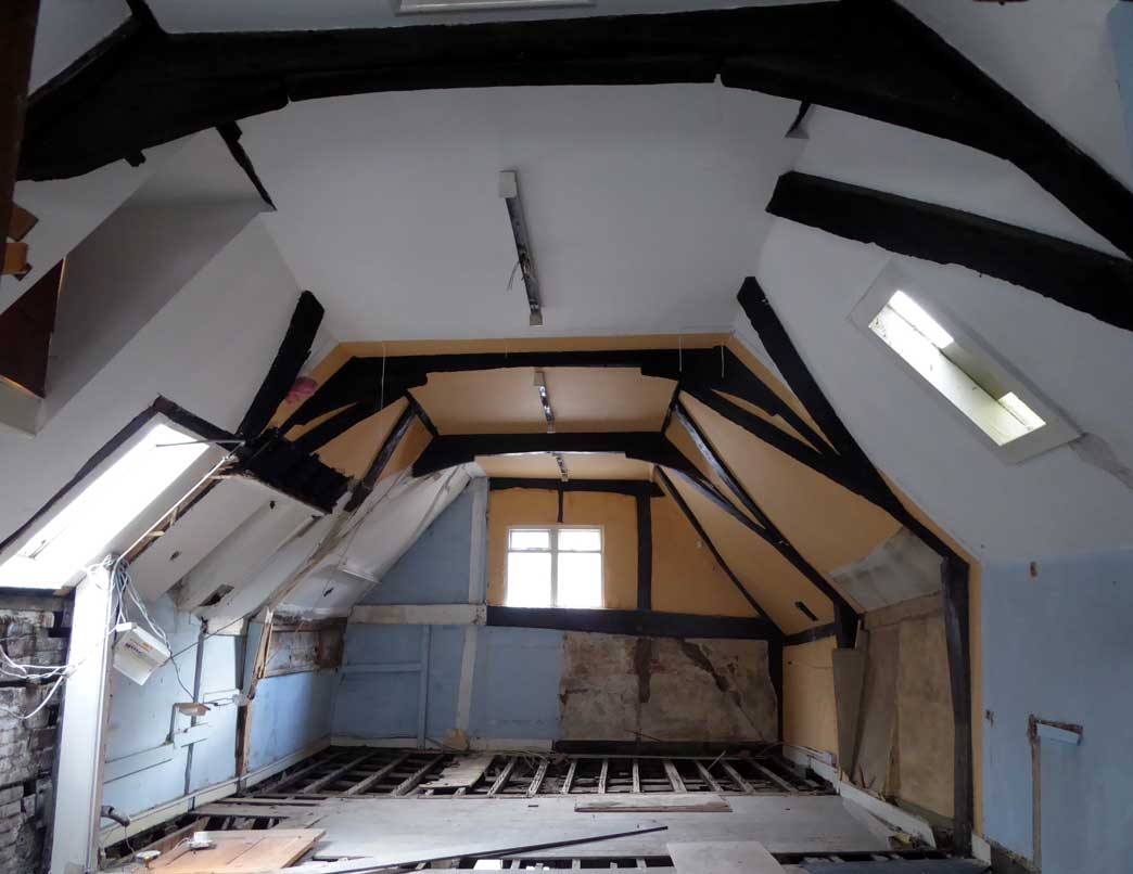 photo inside an attic showing exposed roof timbers